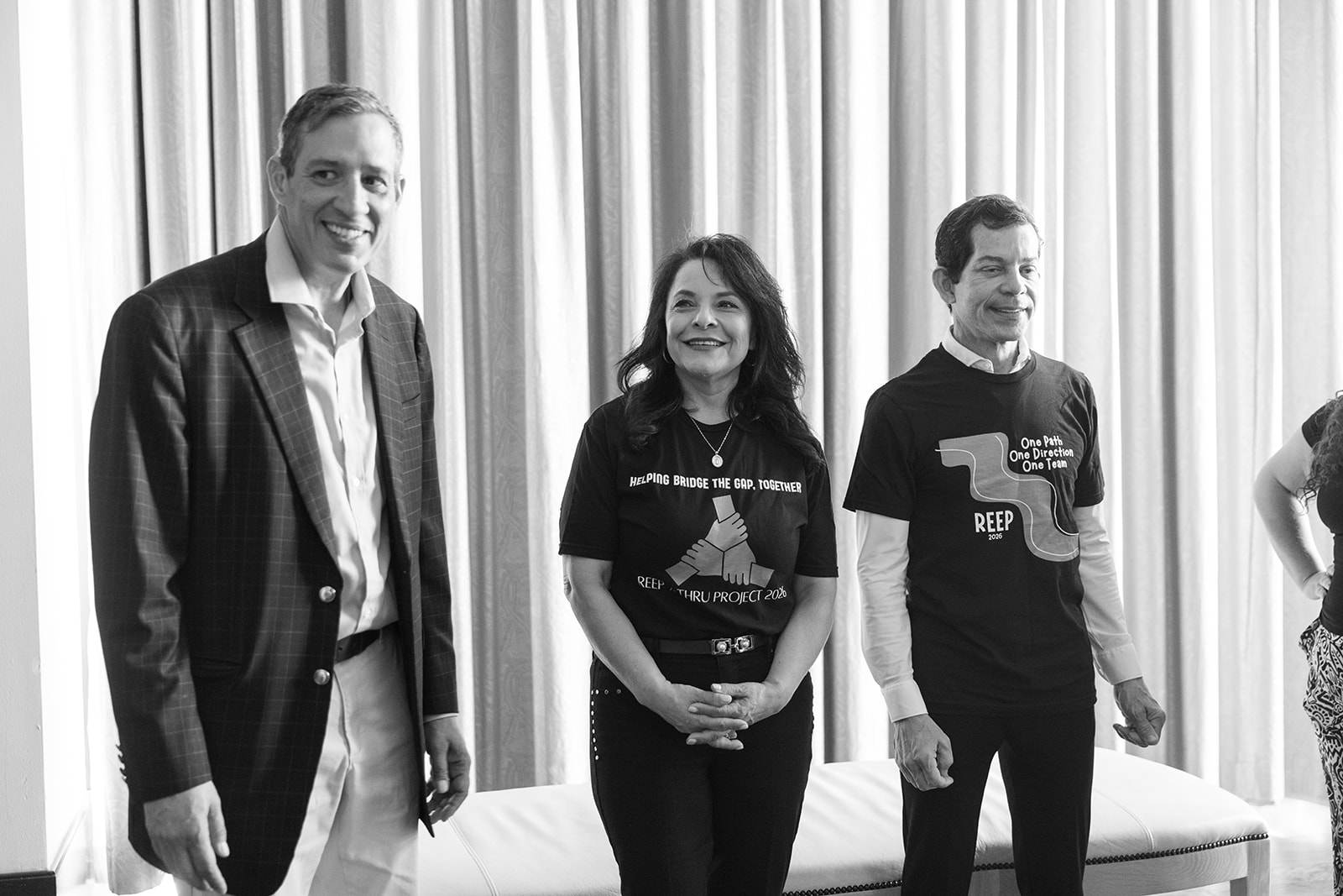 Three REEP leaders posing together in black and white at the packing event
